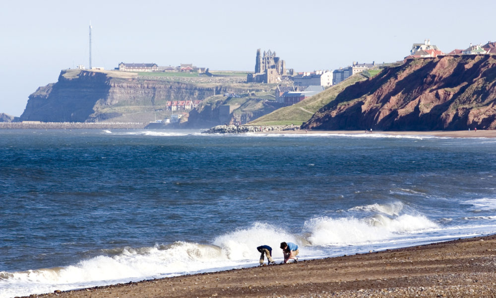 children on Whitby beach, Yorkshire, England