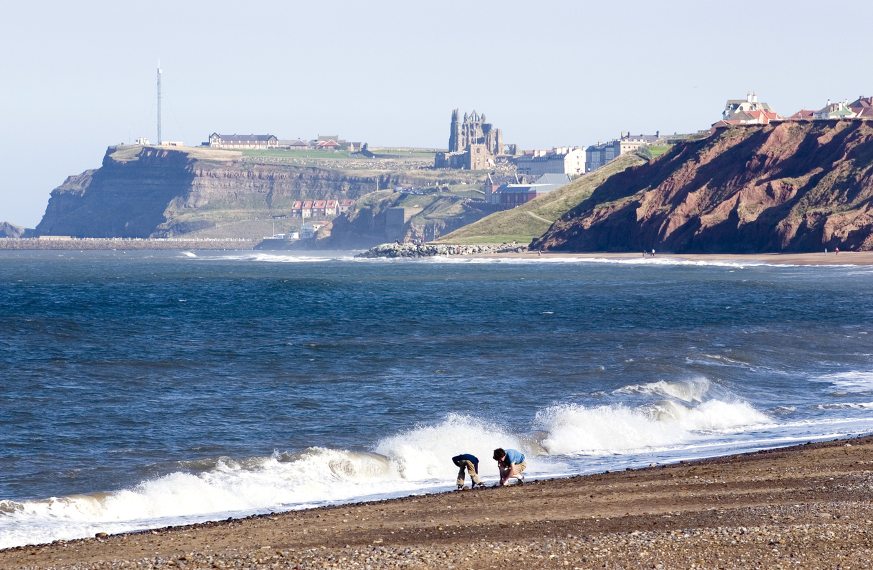 children on Whitby beach, Yorkshire, England